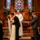 Bride and groom kissing in ceremony