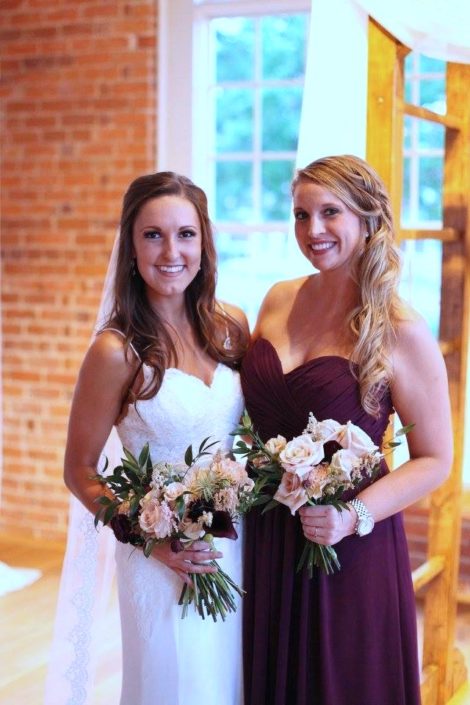 bride with bridesmaid and bouquet