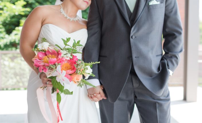 Bride and groom with coral charm peony bouquet