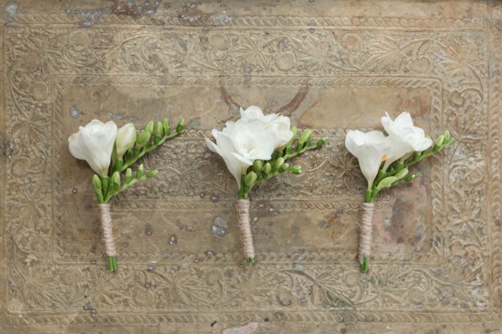 Freesia boutonniers wrapped in twine