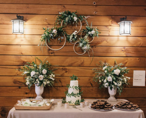 Wedding cake display with floral hoops