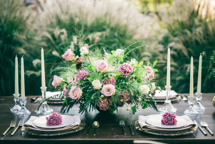 Dusty rose and blush centerpiece on a farm table