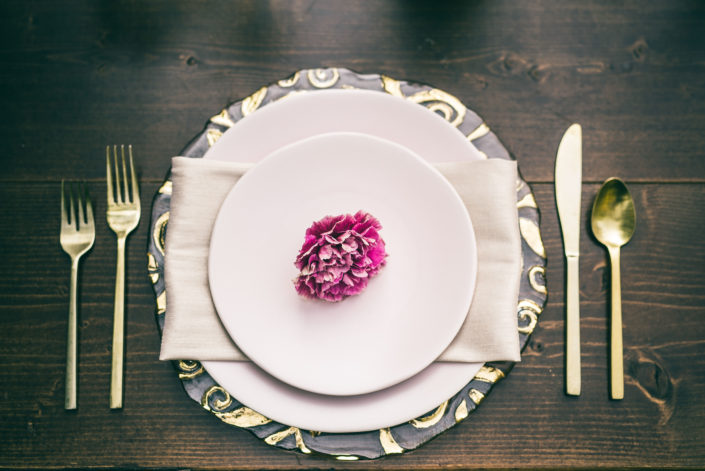 Blush pink place setting with a carnation flower