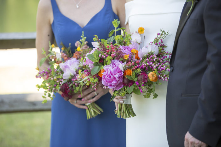 bride with her maid and their bouquets in a blue and spring colors bouquet
