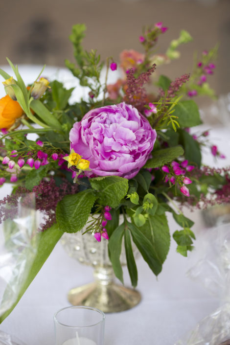 spring flower arrangement with pink peony in a silver compote vase