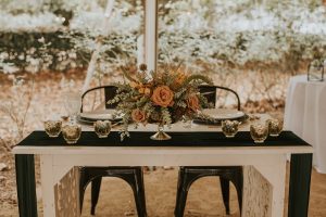sweetheart table Centerpiece with greens dusty coral and texture for boho wedding designed by durham florist poppy belle floral design
