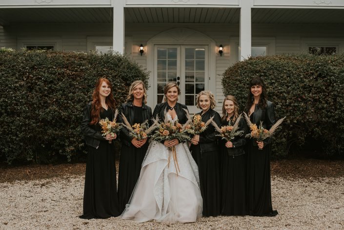 Bridesmaids holding their bouquets withBride holding Bridal bouquet with greens dusty coral and texture for boho wedding designed by durham florist poppy belle floral design