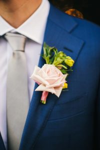 Groom with boutonniere designed by durham florist poppy Belle Floral design