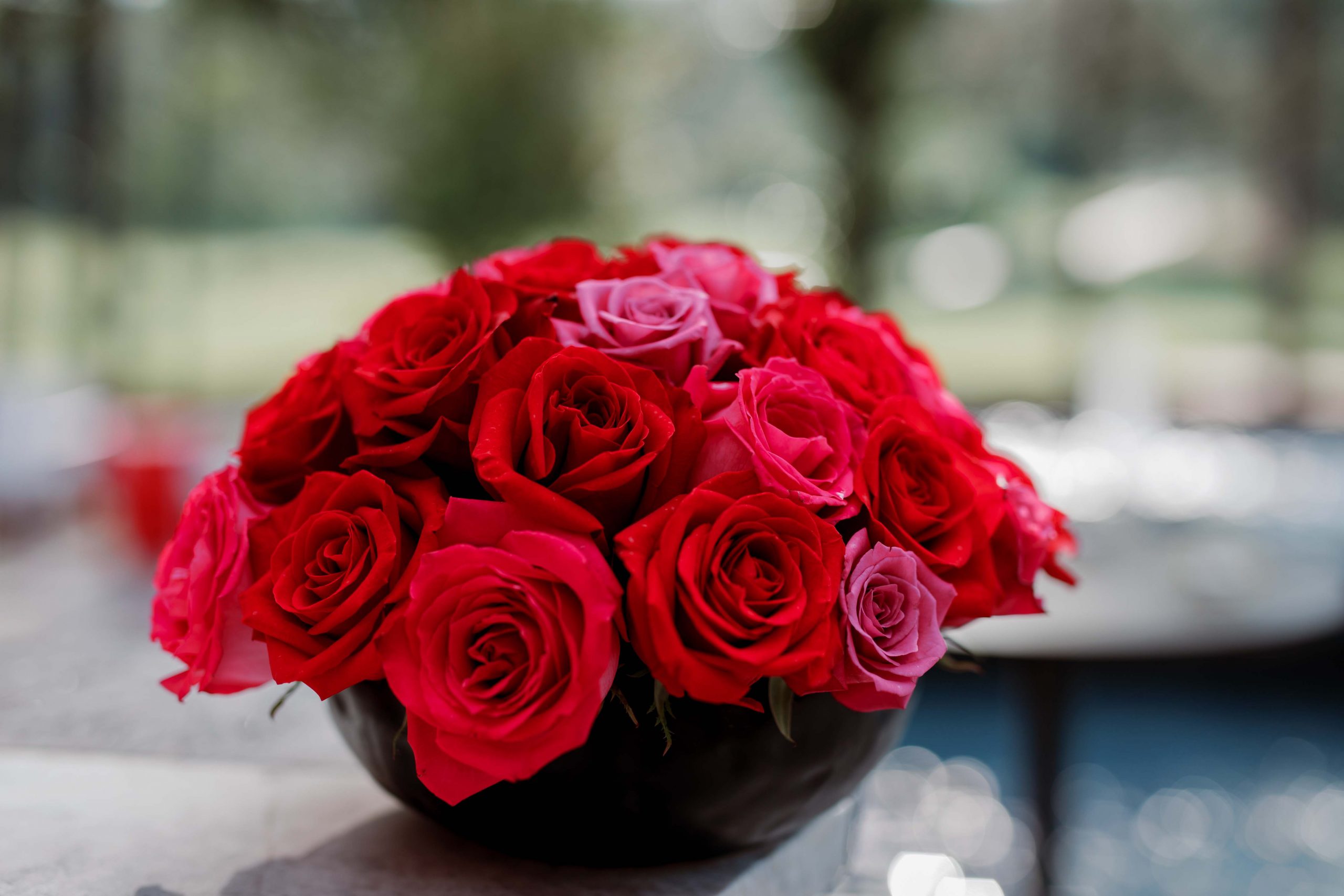 Centerpiece of red roses designed by durham florist poppy belle floral design