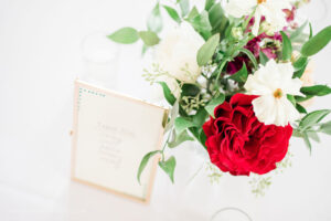 Wedding welcome or guest book table with a floral accent arrangement by Poppy Belle, Durham florist.