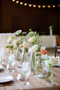 Whimsical bud vase centerpiece for peach wedding at The Sutherland. Floral design by Durham florist, Poppy. Belle.